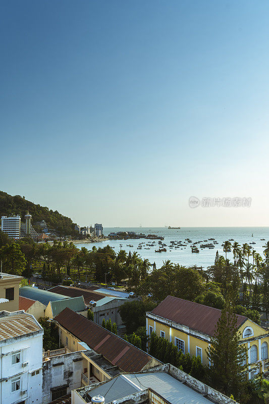 全景的沿海Vung Tau的看法，从上面，海浪，海岸线，街道，椰子树和陶凤山在越南。海上美丽的日落。